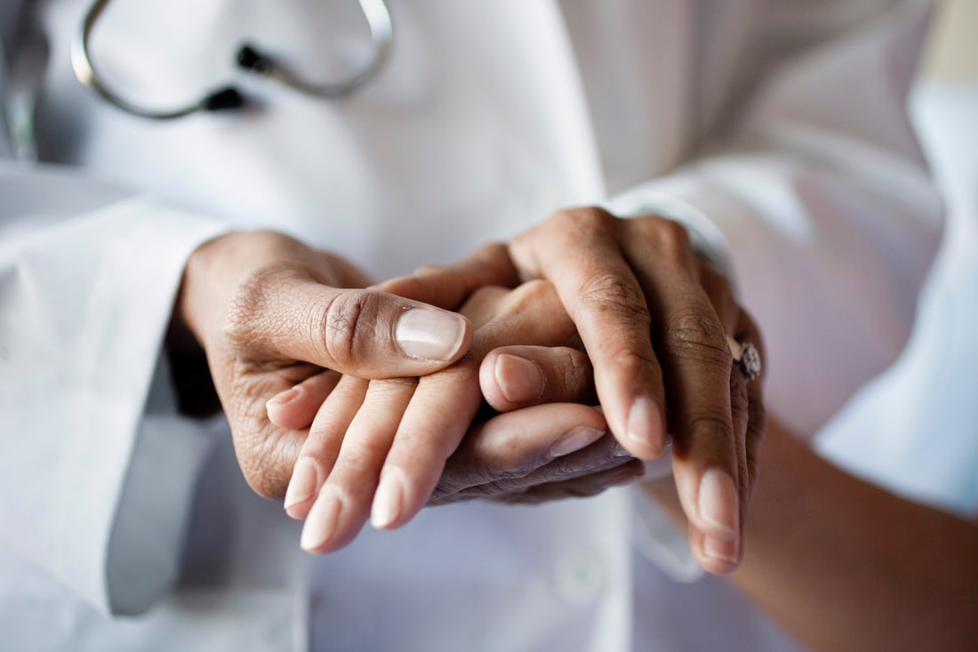 doctor holding patients hand