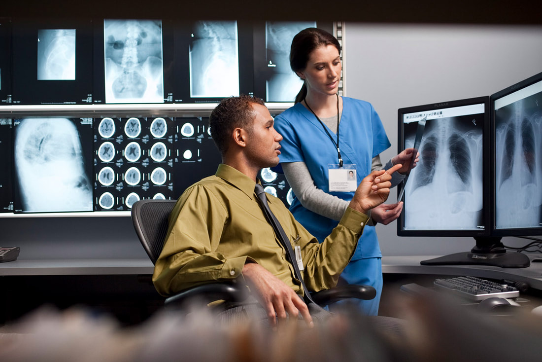 radiologist discussing x-rays with nurse